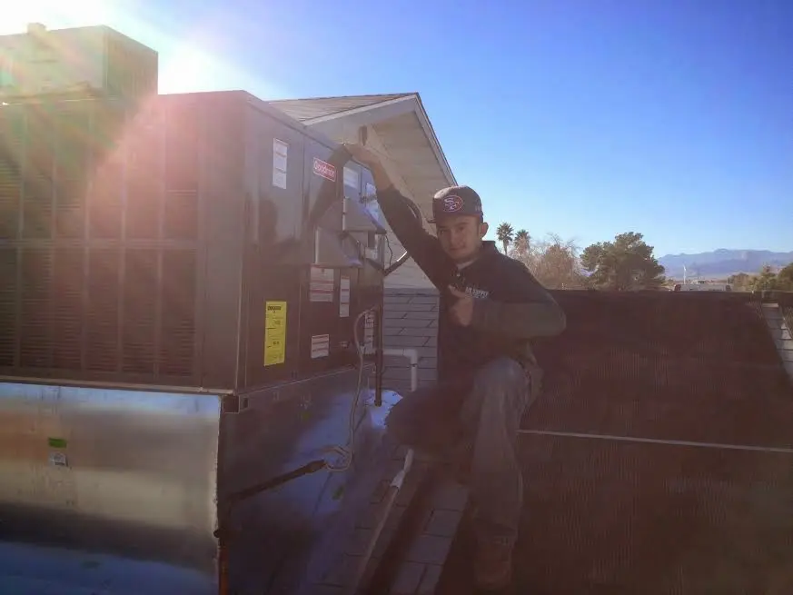 HVAC technician performing Boiler Repair on a rooftop unit in Pittsburgh